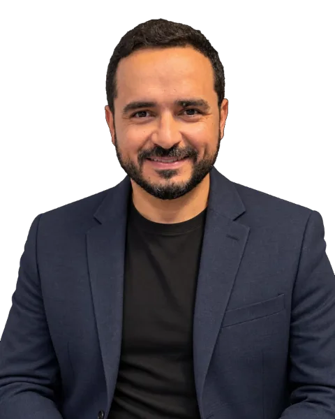Lau Santos sorrindo, de blazer azul-marinho e camiseta preta